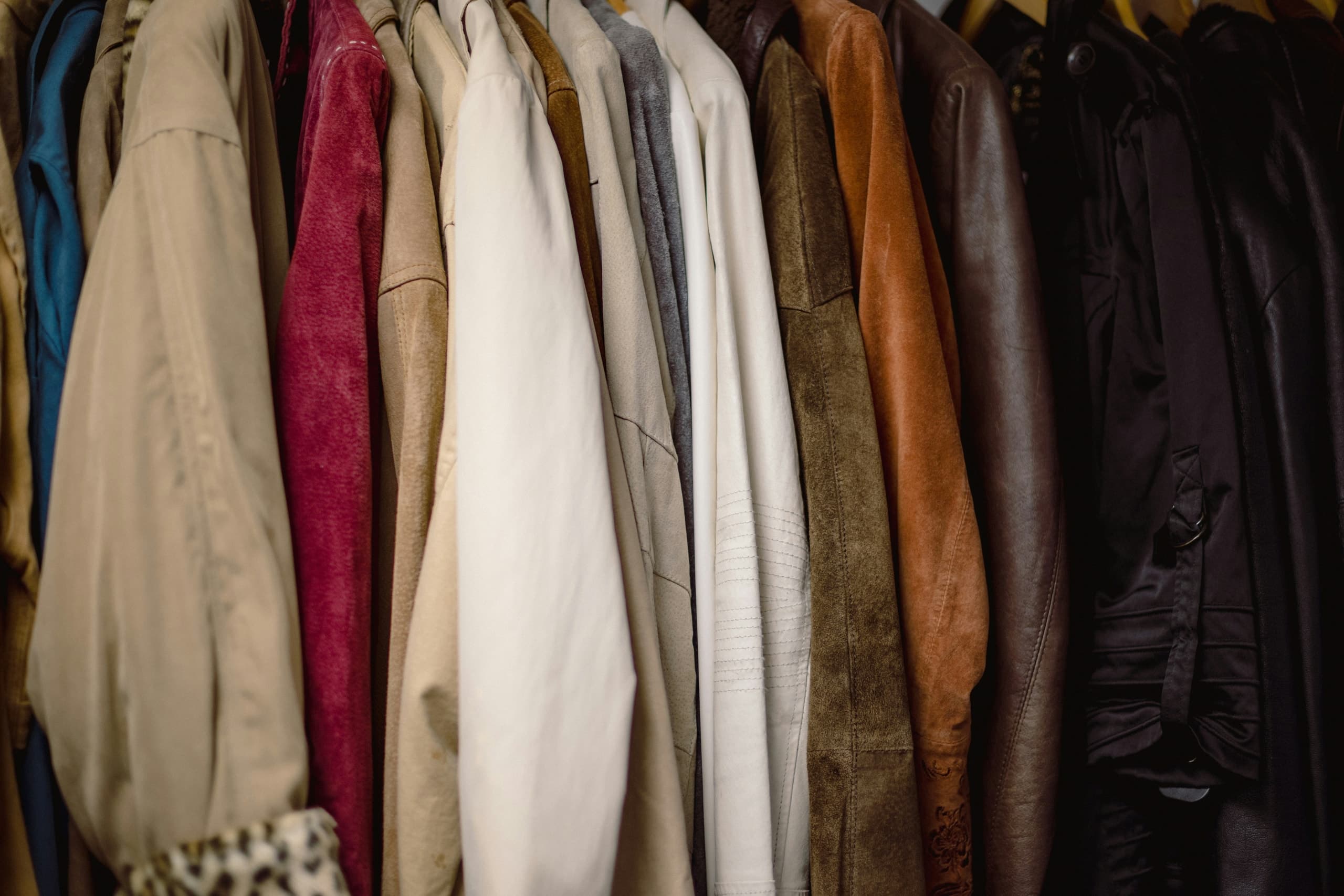 A rack of garments hanging against a wall.